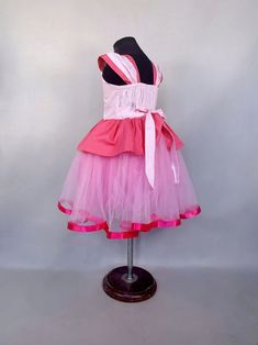 a pink and white dress on a mannequin