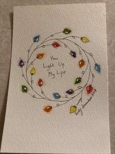 a handmade card with the words, you light up my life and colorful lights around it