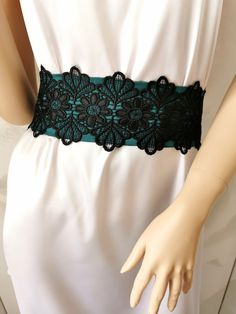 If you would like this belt in a different length or width, please, write to us. The Green (emerald) wide satin belt with lace. This extra long sash is 3 inches wide and 100 inches long. The length of the lace on the belt is 20 inches. Belt material: stretch satin, lace. The satin belt is available in the following colors: 1 White 2 Ivory 3 Champagne 4 Beige 5 Peach 6 Light pink 7 Pink 8 Lilac 9 Dark pink 10 Red 11 Burgundy 12 Terracotta 13 Gray 14 Dark brown 15 Black  16 Dark green 17 Sky blue 18 Royal blue 19 Navy blue  20 Aqua blue Elegant Lace Corset Belt, Elegant Black Corset Belt For Weddings, Lace Corset Belt For Wedding, Lace Wedding Corset Belt, Elegant Lace Wedding Corset Belt, Elegant Wedding Lace Corset Belt, Elegant Lace Bridal Belt For Party, Wedding Black Fitted Corset Belt, Elegant Fitted Lace Bridal Belt