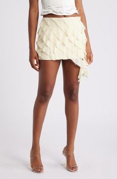 Frothy side ruffles add a sweet, sophisticated flourish to a fluttery tiered miniskirt made from crinkled georgette in a off-white shade. Back zip closure Lined 100% polyester Dry clean Imported Elegant Ruffled Mini Skirt For Spring, Chic Ruffled Mini Skirt For Party, Chic Asymmetrical Ruffled Mini Skirt, Chic Party Mini Skirt With Ruffles, Elegant Spring Mini Skirt With Ruffles, Elegant Ruffled Mini Skirt For Summer, Chic Tiered Pleated Bottoms, Chic Pleated Tiered Bottoms, Tiered Ruffle Mini Skirt For Party