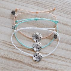 Handmade by us, for you. • 100% Waterproof • Adjustable to fit almost every wrist. Beachy Bracelets With Starfish Charm For Vacation, Beachy Bracelets With Starfish Charm, Beach Season Vacation Bracelets With Starfish Charm, Silver Sand Dollar Necklace, Ocean-inspired Starfish Charm Bracelets For Beach, Braided Strap, Blog Branding, Sand Dollar, Beach Inspired