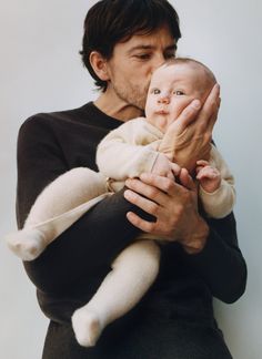 a man holding a baby in his arms