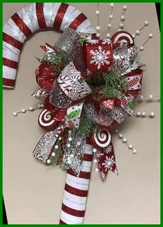 a candy cane decorated with christmas decorations