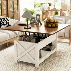 a living room filled with furniture and a coffee table in front of a white couch