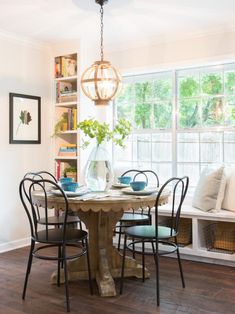 a dining room table with four chairs around it