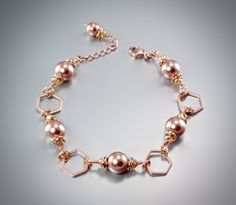 Emphasizing the simple form of hexagon, this geometric bracelet design will add a touch of sophistication to any wedding gown or formal ensemble. Sleek and edgy, this piece is softened by lustrous Swarovski crystal pearls (8mm) and citrine accents set in 14K rose gold-filled components. Rose gold has truly become the season's must-have in jewelry trends. All it takes is a simple glance at this gorgeous metal to see its extremely subtle and classy look that makes a sophisticated and feminine stat Geometric Bracelet, Bracelet Design, Bridal Bracelet, Gold Geometric, Swarovski Pearls, Crystal Pearls, How To Look Classy, Jewelry Trends, Bracelet Designs