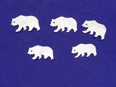 six white polar bears on a blue background are cut out and placed in the shape of an elephant