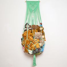 a bag filled with stuffed animals on top of a white floor next to a wall