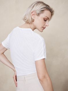 Ideal for channeling the season's ode to 90s sheer styles, this fitted t-shirt is cut from a semi-sheer, ribbed fabric so you can layer it or wear it solo as you please.  Fitted.  Sustainability: Made with TENCEL™ lyocell, a sustainably sourced fiber from responsibly-harvested trees.  Crew neck with button-loop at back.  Straight hem.  Fitted.  Short sleeves.  Hip length.  Model: Size S, 5'10" (178cm). Chic Ribbed Crew Neck T-shirt, Classic T-shirt With Ribbed Neckline For Summer, Fine Knit Short Sleeve T-shirt, Fitted Short Sleeve Top With Ribbed Neckline For Summer, Ribbed Fitted Top T-shirt For Summer, Ribbed Short Sleeve Top For Everyday Summer Wear, Summer Ribbed Fitted T-shirt, Spring Fine Knit Stretch T-shirt, Fitted Summer T-shirt With Ribbed Neckline