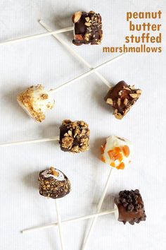 chocolate covered marshmallows are arranged on skewers with the words peanut butter stuffed marshmallows above them