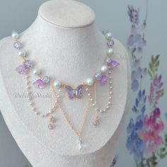 Step into a world of enchantment with our handmade Violet Fairy Blossom Choker Necklace, a magical accessory that captures the essence of fairy and princesscore aesthetics. Adorned with a stunning violet crystal butterfly centerpiece, surrounded by delicate glass beads and flowers, this necklace is designed to add a touch of whimsical charm to your look. 🌸 Key Features: Violet Crystal Butterfly: The centerpiece of this necklace is a captivating violet crystal butterfly, symbolizing transformati Princess Necklace Aesthetic, Fairy Jewelry Bracelet, Purple Butterfly Necklace, Fairy Necklace Diy, Purple Necklace Aesthetic, Butterfly Bead Pattern, Handmade Beaded Necklaces Design, Cute Bracelet Ideas Bead, Purple Fashion Aesthetic