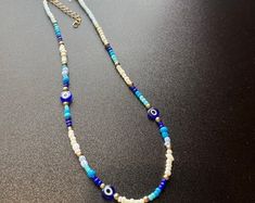 Evil Eye Beaded Necklace - Etsy Trendy Adjustable Evil Eye Necklace, Trendy Adjustable Evil Eye Necklaces, Summer Evil Eye Jewelry With Round Beads, Adjustable Spiritual Beaded Necklace With Evil Eye, Blue Evil Eye Beaded Necklaces, Multicolor Evil Eye Beaded Necklaces, Evil Eye Beaded Necklace, Blue Metal Necklace With Evil Eye, Blue Metal Evil Eye Necklace