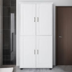 a tall white cabinet sitting next to a bathroom sink