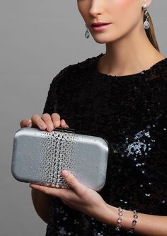 Add a hint of sparkle with this glamorous satin clutch — ELLA is adorned with the highest quality brilliant cut crystals to add the perfect touch of sparkle to any look. Perfect for pairing with a vibrant evening gown to bring out its designs, the Ella Crystal Clutch is a beautiful evening wear clutch with just enough detail to make the accents of your dress shine. Against a smooth and soft satin background layer are clear, sparkly crystals that are heavy in concentration and large in the center Elegant Rectangular Sequin Clutch, Chic Crystal-embellished Evening Bag For Cocktails, Designer Silver Clutch For Formal Events, Designer Silver Clutch For Formal Occasions, Designer Silver Clutch For Event, Designer Silver Clutch For Events, Elegant Rectangular Evening Bag With Sequins, Rhinestone Clutch For Gala, Designer Rhinestone Evening Bag For Parties