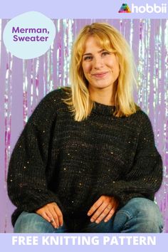 a woman sitting in front of a purple background wearing a black sweater with sequins