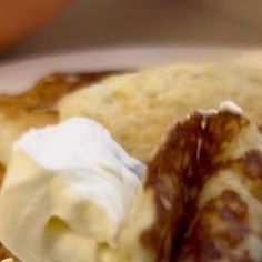 pancakes with whipped cream are on a plate