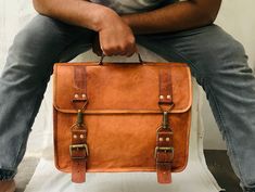 Features: Color: Vintage Brown Size: 11* 15 * 4 inches Material: Top Grain Goat Leather Inner Lining: Canvas Buckle: Brass Polished Detachable Shoulder Strap Get yourself this uptown and classic brown messenger bag that fits with your professional look and adds a sense of style when you head to your workspace. The big comes with wide compartments that easily accommodates your laptops and various other belongings. You can easily carry this bag with a shoulder strap or the handle on the top. The t Brown Messenger Bag, Brown Leather Messenger Bag, Messenger Bag Leather, Leather Tote Bag Women, Laptop Briefcase, Leather Cross Body Bag, Classic Brown, Leather Handbags Tote, Color Vintage