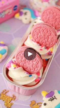 an oreo cookie in a pink container with sprinkles on the table