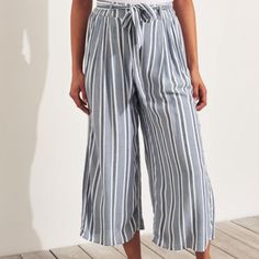 Hollister Ultra High Rise Culottes Womens S Chambray Blue Nwt Discontinued Viscose Machine Wash Crop Lightweight Non Stretch Woven Construction Back Elastic Waistband Belt Loops Tie Belt Pull On Lined Side Pockets Also Shown In Dark Navy Stripe Blue Summer Pants For Beach, Blue Summer Pants For Beach Season, Blue Bottoms For Brunch In Spring, Striped Wide-leg Summer Pants, Chic Blue Bottoms For Beach Season, Chic Striped Bottoms For Beach, Chic Striped Bottoms For Beach Season, Blue Pants For Summer Day Out, Striped Trousers For Summer