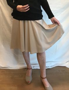 Beige skirt with angled seam going down from the high hip to the hem. The lower half has a lovely draped flare, making this a great skirt for day wear or dancing. The skirt has a side zipper and measures 44cm (17") across the waist and is 64cm (25") long. It is made from a fine twill-weave polyester fabric. One only - made from my fabric stock. Check out my other listings and combine the postage. Beige A-line Pleated Skirt For Fall, Beige Pleated Asymmetrical Skirt, Chic Beige Stretch Pleated Skirt, Chic Stretch Beige Pleated Skirt, Classic Beige Knee-length Bottoms, Cream Pleated Lined Skirt, Cream Asymmetrical Flowy Skirt, Cream Pleated Flowy Flared Skirt, Fitted Beige Pleated Skirt For Fall