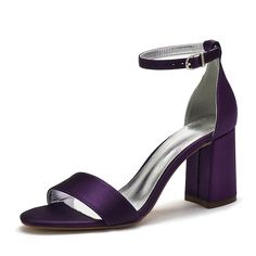 a woman's purple high heeled sandal with ankle strap