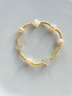 "This beautiful pearl & gold filled bead  bracelet is a perfect addition to a dainty stack. The freshwater pearls and the gold filled beads are strung on a premium stretch cord. For best fit, measure your wrist at the wrist bone with a measuring tape or string. Add 1/2\" to that measurement for a snug fit, 3/4\" - 1\" for a comfort fit, or 1\" or larger for a loose fit. About gold filled jewelry: We use only the BEST materials, and with proper care, cleaning and storage your items can last a lif Dainty Stackable Pearl Bracelet With Round Beads, Dainty Stackable Pearl Beaded Bracelets, Dainty Gold Stretch Bracelet With Gold Beads, Dainty Gold Stretch Bracelet, Delicate Handmade Gold Beaded Bracelets, Delicate Stackable Beaded Bracelets With Round Beads, Delicate Beaded Bracelets With Pearl Charm, Dainty Beaded Bracelet With Pearl Charm, Dainty Pearl Beaded Bracelets With Tiny Beads