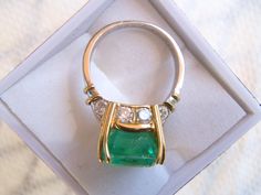 Simply sublime. This unique ring is the highlight of my Etsy collection. A rare stunner with an 8+ carat emerald and one carat total weight in white diamonds. This was a custom handmade ring I helped to design, and picked the stones myself, a rectangular shape natural emerald, gauging 13.00 x 10.40 x 9.00mm, exact weight 8.13 carats. 10 round brilliant cut diamonds accent the ring. One of the premier jewelers here in Wine Country made it; the top in pure 18K yellow gold and the shank in platinum Gold Statement Ring, Green Emerald, Emerald Diamond, Round Brilliant Cut Diamond, Brilliant Cut Diamond, Statement Ring, Unique Rings, Matching Earrings, Diamond White