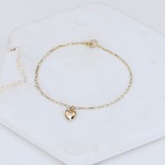 "14k Gold Heart Bracelet - Dainty 14K Gold Bracelet ★ The chain is 14k solid gold ★ The components are 14K yellow gold ★ The small heart charm is about 11 mm x 6mm, it is hollow 14k gold. The length includes the chain and the closure. ** How to choose a correct size of bracelet. 1. Measure your wrist below the wrist bone using a flexible tape measures, a string or a strip of paper. 2. If using a string or a strip of paper, mark length. Then, measure it with a ruler. 3. To find the bracelet size, 14k Yellow Gold Charm Bracelet For Everyday, Everyday 14k Yellow Gold Charm Bracelet, 14k Gold Bracelet With Heart Charm For Everyday, 14k Gold Delicate Heart Charm Jewelry, Dainty Yellow Gold Chain Bracelet For Valentine's Day, Dainty Gold Bracelet With Heart Charm, Dainty 14k Gold Jewelry With Heart Charm, Dainty 14k Yellow Gold Filled Bracelet, Delicate Yellow Gold Heart Bracelet With Charm