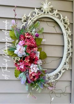 a floral wreath hanging on the side of a house