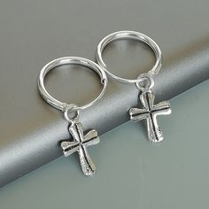 Comes with a detachable cross charm. The charm is multipurpose and can be used with a neck or bracelet chain too. Dimension: Hoop- 12 x 1.2 mm Cross: 7 x 12 mm Weight: 0.70gm Price listed is for a PAIR of hoops. These earrings are made of 925 hypoallergenic sterling silver and comes with a 925 stamp. Can be packaged in a gift box. I can include a personal message from you if needed You are welcome to contact me at... bhavnakwintra1956@gmail.com For more beautiful pieces from my shop, please brow Silver Nickel-free Huggie Hoop Earrings, Nickel-free Silver Dangle Huggie Earrings, Silver Dangle Huggie Earrings Nickel-free, Silver Nickel-free Dangle Huggie Earrings, Silver Huggie Earrings With Charms, Silver Small Hoop Huggie Earrings For Gift, Silver Dangle Hoop Earrings With Charms, Silver Dangle Huggie Earrings With Charms, Silver Huggie Earrings With Charms In Small Hoop Shape