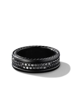 a black and white photo of a ring with diamonds on the inside, in front of a white background