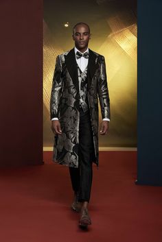 This luxury grey metallic patterned tuxedo for men or women is perfect for exclusive formal events. The three piece extended jacket is a detailed addition to elevate your collection. FREE SHIPPING ON ORDERS OVER $199 COLOR Black/Silver COMPOSITION N/A YARN COUNT N/A WEIGHT 290g FABRIC STYLE Jacquard OCCASION Wedding/Gala Luxury Sets For Black-tie Festive Events, Luxury Festive Sets For Black-tie Events, Luxury Three-piece Suit For Party, Elegant Gray Three-piece Suit, Fitted Silver Blazer For Evening, Luxury Silver Outerwear For Parties, Elegant Black Three-piece Suit For Winter, Elegant Formal Winter Sets, Elegant Holiday Suits