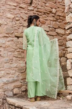 Indulge in opulent luxury with our Mint Green Embroidered Kurta Set. Made with shantoon, this set exudes sophistication and is paired with a Chanderi dupatta for added elegance. Featuring intricate embroidery, this piece celebrates traditional Indian heritage. Elevate your style with this exclusive ensemble. No. of pieces - 3 piece set. Color - Mint Green. Fabric - Shantoon. Washing Instructions - Dry Clean. Slub Silk Sets With Dori Work For Wedding, Embroidered Tissue Silk Anarkali Set, Silk Sets With Chikankari Embroidery, Festive Embroidered Cotton Silk Palazzo Set, Slub Silk Wedding Sets With Dori Work, Pista Green Slub Silk Sets With Dupatta, Pista Green Embroidered Slub Silk Set, Green Chanderi Sets With Chikankari Embroidery, Festive Cotton Silk Palazzo Set With Intricate Embroidery