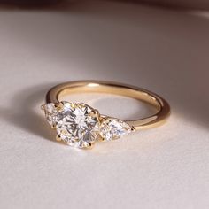 three stone diamond ring on white surface