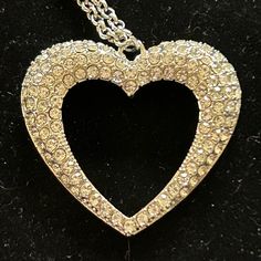 A Flared Silver Heart Is Encrusted In Glassy White Rhinestones, Resulting In A Romantic Shimmer At The Bottom Of An Extended Silver Chain. Never Worn. Crystal Heart Pendant Necklace For Party, Elegant Heart Necklace With Rhinestones For Parties, Heart-shaped Rhinestone Necklaces For Party, Silver Crystal Heart Necklace With Rhinestones, Party Crystal Rhinestone Heart Pendant Necklace, Heart Shaped Rhinestone Party Necklace, Glamorous Heart-shaped Rhinestone Jewelry, Glamorous Heart-shaped Crystal Necklaces, Glamorous Silver Necklace For Valentine's Day