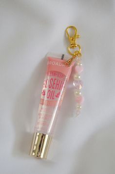 This lip gloss keychain is just the perfect accessory to personalize your beauty essentials or to gift to a friend. Attached to the lip gloss is a cute beaded charm and an initial charm of your choice.  Add this cute keychain to your keys, purse, or etc to have your lip gloss with you at all times.  D E T A I L S  - this keychain includes the lip gloss.  - Please note that due to photo editing, lighting, and screen settings, colors on the photos may be slightly different than the colors in perso Lip Gloss Decoration, Affordable Pink Glasses Chains For Gifts, Phone Key Chain, Lip Gloss Keychain Diy, Lip Gloss Charms, Lip Keychain, Diy Keychain Ideas, Dance Gift Ideas, Lip Gloss Keychain