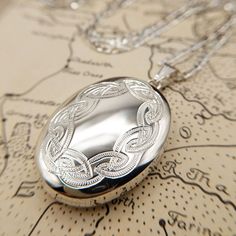 Metal: Sterling Silver Locket Size: 3.4cm x 2.6cm Locket Weight: 8.1 grams Hallmarked: Yes Chain Length: 20, 22 & 24 inch Chain Weight: 5-7 grams Link Style: Figaro, 2mm wide Hallmarked: No (under 7.78 grams) A fabulous quality large oval locket with an engraved celtic knot design the front. The locket is made from solid sterling silver and it has two spaces inside for photos. Available on a sturdy silver figaro chain 20-24 inches in length. Fantastic, hand made in Britain jewellery. *RETURNS* W Silver Figaro Chain, Silver Locket Necklace, Celtic Knot Designs, Sterling Silver Locket, Oval Locket, Silver Locket, Knot Design, Figaro Chain, Silver Lockets