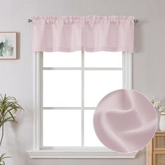 a window with pink ruffled curtains and a potted plant next to the window