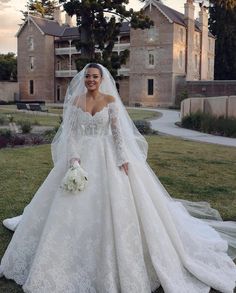 a woman in a wedding dress posing for the camera