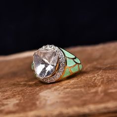 a diamond ring sitting on top of a wooden table