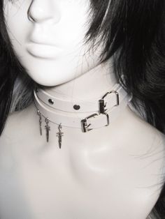 This double-wrap choker is a statement piece that adds an edgy flair to any outfit. The choker features stud embellishments and a distinctive sword pendant, creating a bold and unique look.  Please note that the price includes one choker only. Adjustable Punk Choker For Cosplay, Adjustable Punk Style Choker For Cosplay, Adjustable Emo Choker For Cosplay, Edgy Silver Choker For Cosplay, Rocker Style Festival Choker Jewelry, Adjustable Emo Choker For Alternative Fashion, Edgy Adjustable Choker For Festival, Edgy Adjustable Festival Choker, Adjustable Edgy Festival Choker