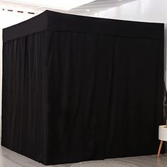 a room with a black cover on the floor