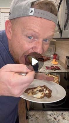 a man eating food with a spoon in his mouth while wearing a headband and looking at the camera