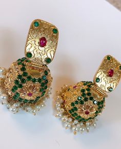 High end quality and Design.  Gold Polished for lasting shine.  studded with semi precious stones. Fusion Style Festive Jhumkas With Stone Work, Festive Fusion Jhumkas With Stone Work, Fusion Style Tilla Jhumkas Drop Earrings, Fusion Kundan Jhumkas With Stone Work, Fusion Style Kundan Jhumkas With Stone Work, Traditional Green Earrings For Reception, Elegant Tilla Earrings For Navratri, Elegant Navratri Jhumkas, Festive Fusion Style Jhumkas With Tilla