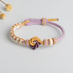 Description: The Mandala Peach Blossom Knot Bracelet is a handcrafted masterpiece, woven with precision and love. This bracelet offers a delicate yet durable design with a 3mm thickness and an adjustable perimeter of 18cm, making it perfect for any wrist size. The mandala-inspired knot and peach blossom elements symbolize beauty, harmony, and balance. Ideal for daily wear or as a thoughtful gift, this bracelet is more than just an accessory – it's a statement of elegance. Handwoven craftsmanship Peach Bohemian Bracelet For Gift, Handmade Adjustable Peach Bracelets, Chinese Braided Bracelet, Pink Bohemian Woven Braided Bracelet, Adjustable Peach Bracelet, Peach Blossom, Knot Bracelet, Peach Blossoms, Daily Wear