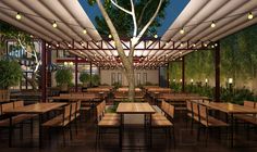 an outdoor dining area with tables and chairs under a canopy at night, surrounded by greenery