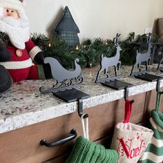 christmas decorations are displayed on the counter in front of santa claus and other holiday items