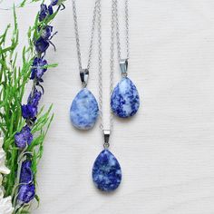 This necklace is made from a sodalite stone which has been cut into a teardrop. The stone hangs from a silver plated chain. You can choose the length of the necklace you prefer. You will get a necklace at random. Please note that all necklaces are handmade and may differ from the pictured. The picture shows multiple necklaces. You will receive one necklace with one pendant. Ewelina Pas Jewelry Silver Teardrop Crystal Necklace With Natural Stones, Silver Sodalite Necklace With Natural Stones, Gift Teardrop Pendant Drop Necklace With Natural Stones, Lapis Lazuli Teardrop Necklace For Gift, Teardrop Lapis Lazuli Necklace For Gift, Multiple Necklaces, Necklace Layering, Teardrop Necklace, May 31