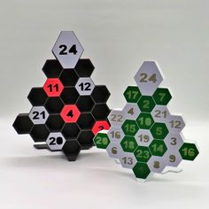 three hexagonal pieces with numbers on them sitting side by side in front of each other