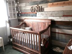 a baby crib in front of a wooden wall